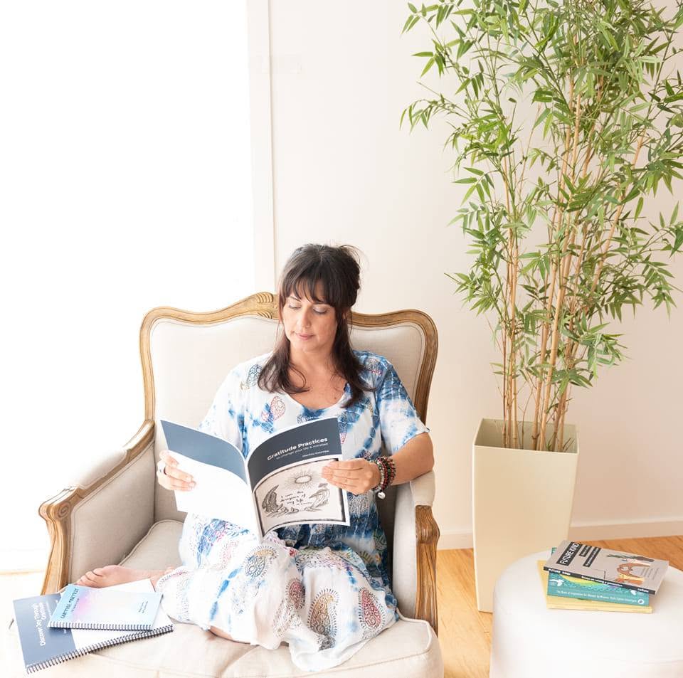 Marilou Coombe reading her gratitude practices workbook